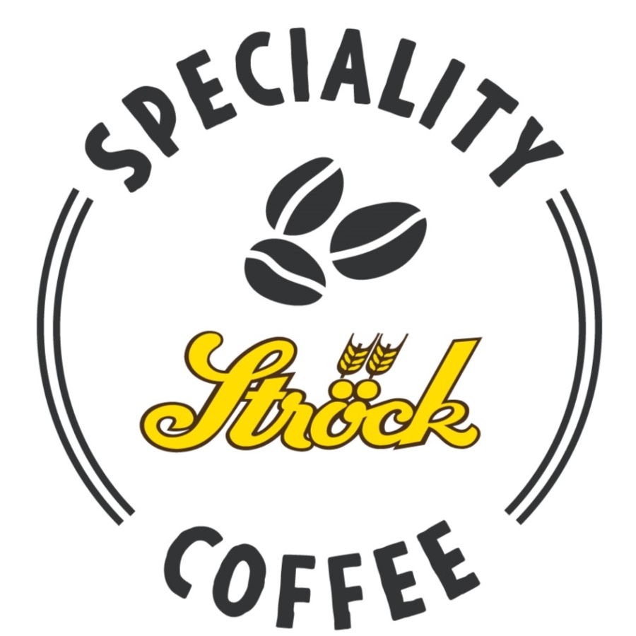 Ein rundes Logo mit dem Schriftzug Speciality Coffee außen herum, drei Kaffeebohnen in der Mitte und Ströck in gelber Schrift mit zwei Weizensymbolen über dem o.