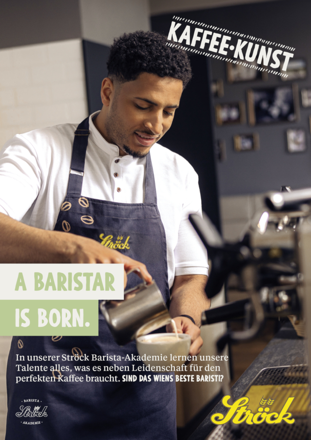 Ein lächelnder Barista in einer Ströck-Schürze bereitet in einem gemütlichen Café Kaffee an einer Espressomaschine zu. Der Text auf dem Bild lautet "Kaffee-Kunst" und "A Baristar is born". Ein weiterer deutscher Text beschreibt die Ströck Barista Academy.